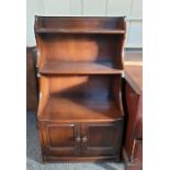 Waterfall bookcase finished in dark elm with two cupboard doors under