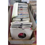 Case of 45rpm singles to include examples by The Bee Gees, The Buzzcocks, Bob Marley, Boney M, The