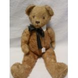 Large gold plush straw stuffed bear with glass eye