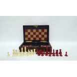 Figured walnut and brass-bound games box, rounded oblong and fitted with bone chess pieces, counters
