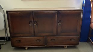 Dark elm Ercol sideboard, three cupboard doors above two drawers, 129cm x 76cm