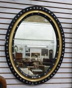 Black ebonised, gilt and cut glass button applied oval wall mirrorCondition ReportThe dimensions are