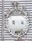 Oval wall mirror in a white painted naturalistic leaf frame