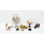 Large exotic shell on ebonised turned wood stand, large quantity of shells in glass pedestal bowl,