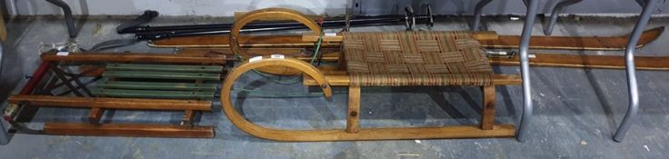 Two vintage sledges, a pair of wooden vintage skis and two ski poles (6)