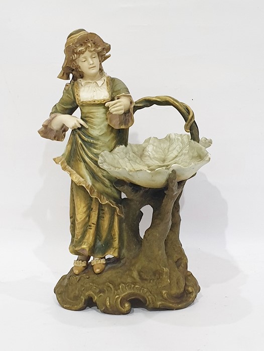 Royal Dux tinted bisque porcelain figure of a young lady in 18th century dress with leaf-pattern