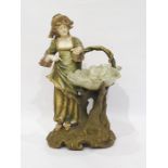 Royal Dux tinted bisque porcelain figure of a young lady in 18th century dress with leaf-pattern