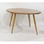 Light elm Ercol circular coffee table on beech supports, 73.5cm diameter