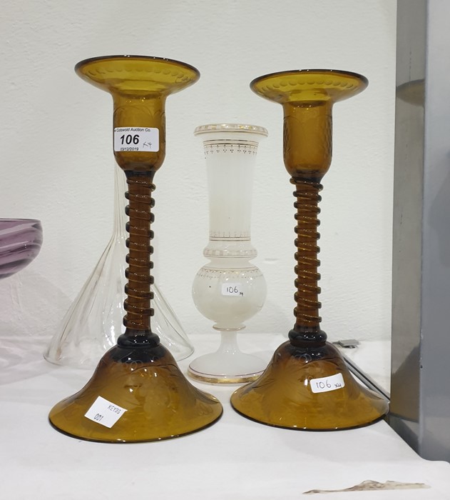 Pair engraved amber glass table candlesticks, each with spirally wrythen column and on dome-shaped