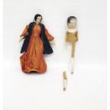 Painted wooden doll and a fabric covered early costume doll in Middle Eastern dress with metal