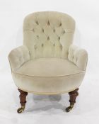 Late Victorian button-back grey upholstered chair on turned and carved supports, to brass caps and