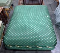 Large pouffe on green ground bee-pattern upholstery, on four bun feet