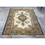 Cream ground Persian rug with central stepped medallion, foliate decorated field, stepped border,