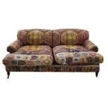 George Smith Ltd sofa in the manner of Howard of London, ethnic covering, turned supports, brass