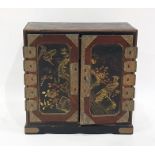 Japanese lacquered and painted table-top cabinet with three drawers enclosed by pair panel doors,