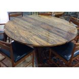 1970's Heals rosewood extending dining table of circular form, on four rectangular supports (CITES