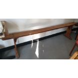 Pair of 19th century French cherrywood long benches on trestle end supports (2)