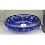 Large blue overlay cut glass bowl with incurved rim and formal swag, palmette and foliate