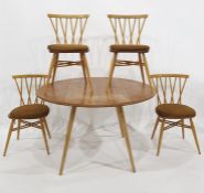 Light elm Ercol dropleaf dining table raised on beech supports and four Ercol Windsor candlestick