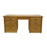 Modern oak desk with seven assorted drawers, 180cm x 80.5cm
