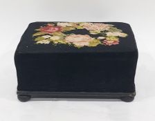 Black velvet and woolwork tapestry rectangular footstool embroidered with wreath of roses