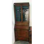 20th century oak bureau bookcase with leaded glazed doors enclosing shelves above the fall, three