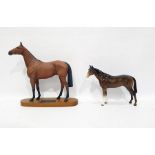 Beswick Connoisseur tinted bisque model horse "Red Rum" on wooden plinth base, 32cm high overall and