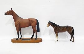 Beswick Connoisseur tinted bisque model horse "Red Rum" on wooden plinth base, 32cm high overall and