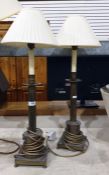 Pair of brass table lamps,with turned brass  cylindrical columns on square base, raised upon bun