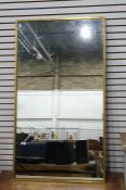Rectangular mirror in brass frame, 70cm x 125cm Condition ReportSome pitting/ dark spotted marks
