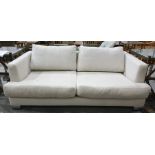 Three-seater sofa in cream ground upholstery, chrome feet