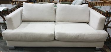 Three-seater sofa in cream ground upholstery, chrome feet