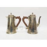 Edwardian silver coffee pot and hot water jug, the conical bodies with stepped bases, wooden