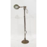 Brass spot lamp on floor-standing telescopic frame