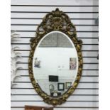 Oval wall mirror in moulded gilt frame