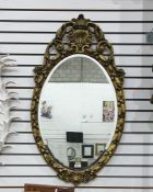 Oval wall mirror in moulded gilt frame