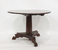 Regency style mahogany circular breakfast table, the circular top on tapered column and concave