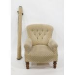 Beige ground upholstered buttonback armchair and spare roll of fabric