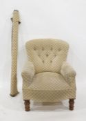 Beige ground upholstered buttonback armchair and spare roll of fabric