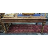 Eastern hardwood rectangular dining table with iron bandings on four turned supports, 185cm long