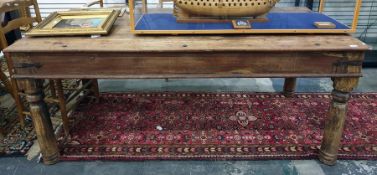 Eastern hardwood rectangular dining table with iron bandings on four turned supports, 185cm long