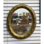 Oval wall mirror in a gilt frame