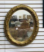 Oval wall mirror in a gilt frame