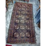 Belouch rug, blue ground, central field with 21 elephant foot guls interspersed stepped border,