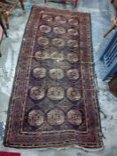 Belouch rug, blue ground, central field with 21 elephant foot guls interspersed stepped border,