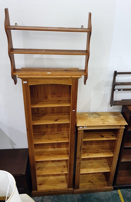 Two 20th century pine narrow open bookcases and a wall hanging shelf (3)