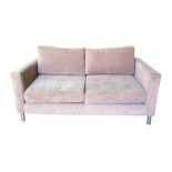 Modern two-seater sofa finished in brown upholstery