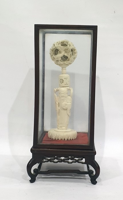 Chinese carved ivory part puzzle ball on stand, 19th century, the ball exterior carved as