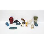 Poole Pottery model dolphin, two Poole Pottery model otters, two Poole Pottery vases, various, and a