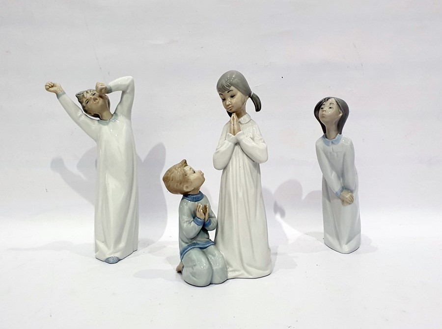 Lladro group of two children saying their prayers and two other Lladro figures of children in